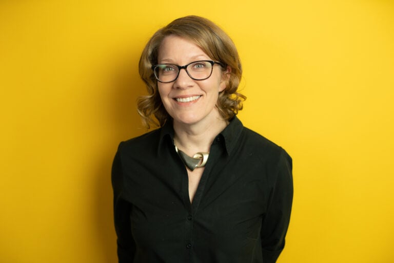 a person wearing glasses and a black shirt