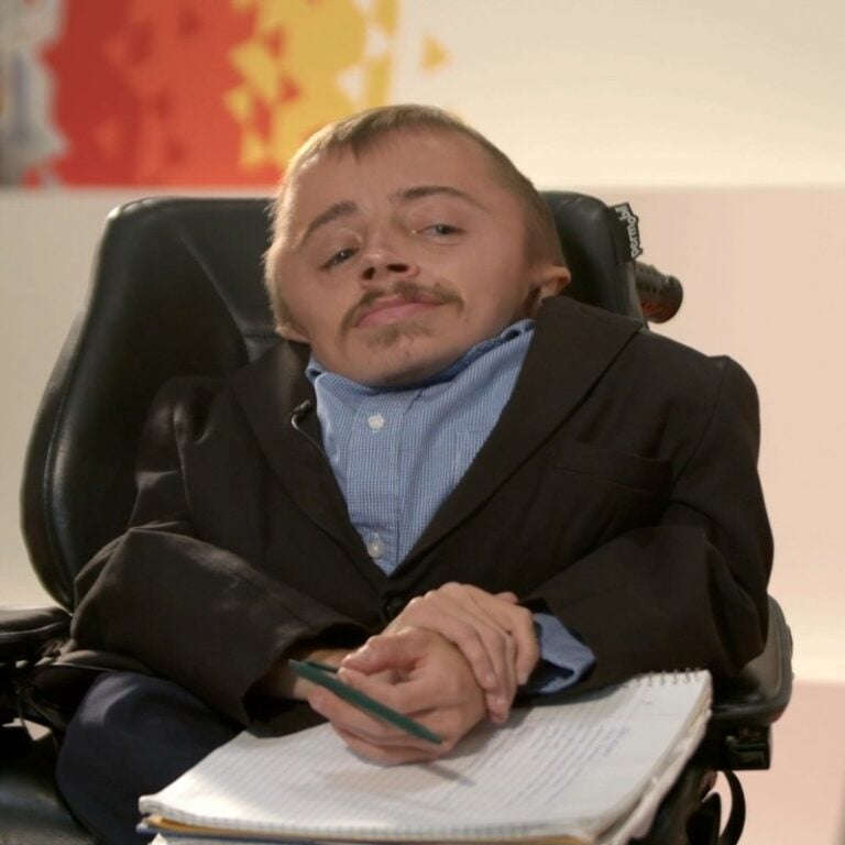 a person in a wheelchair holding a pen