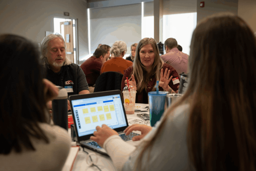 group of people sitting at a table collaborating
